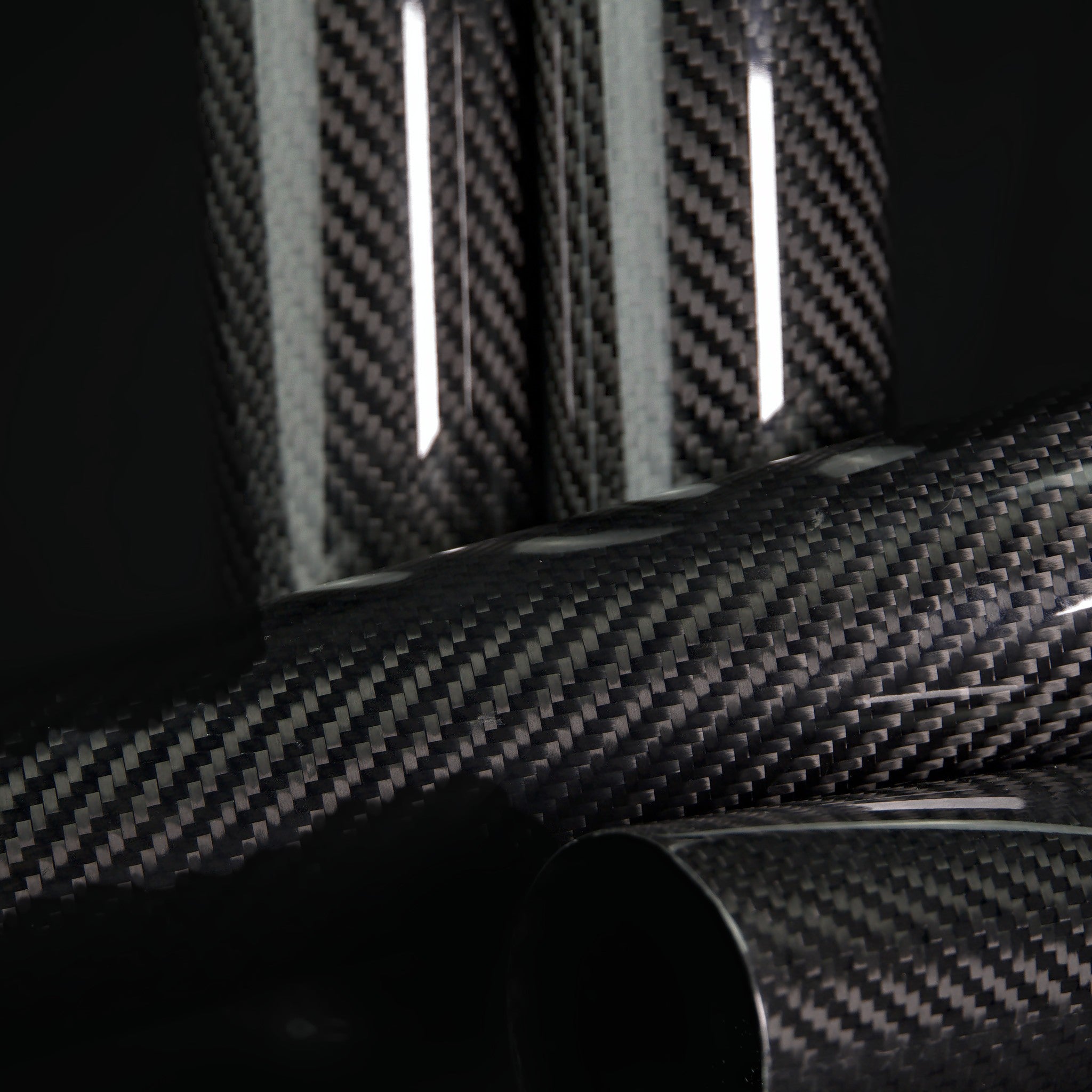 Carbon fiber fork covers lying with Sveacarbon logo end caps