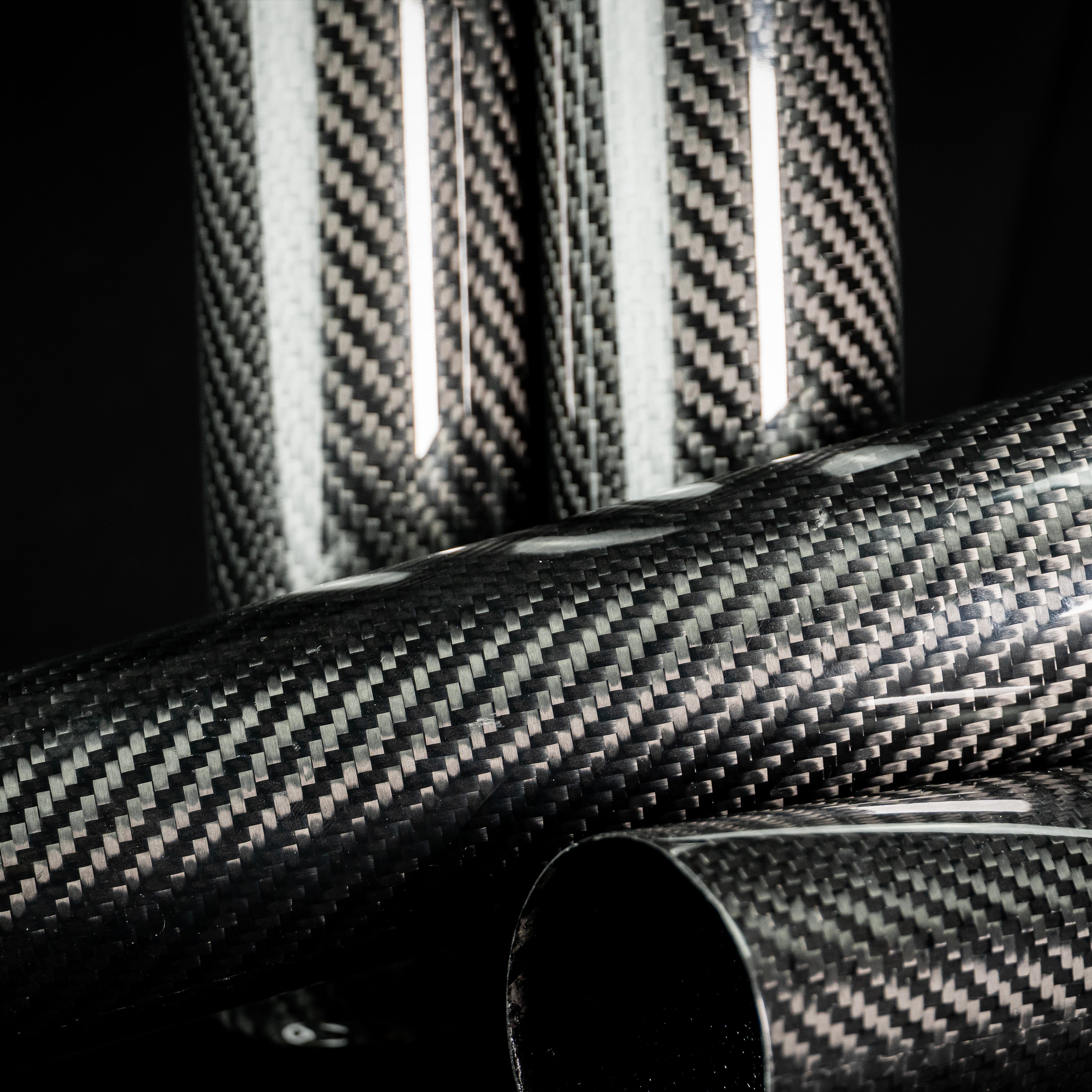 Full-length carbon fork covers lying with Sveacarbon logo end caps